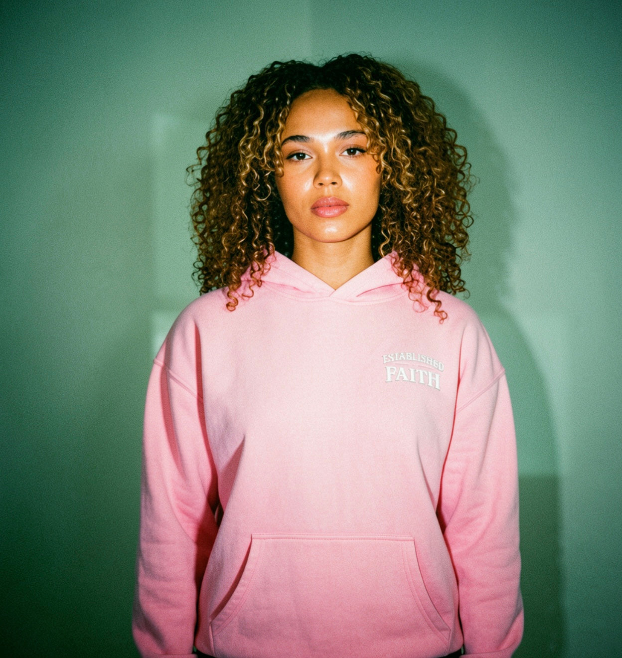 Young adult wearing oversized Christian hoodie outdoors