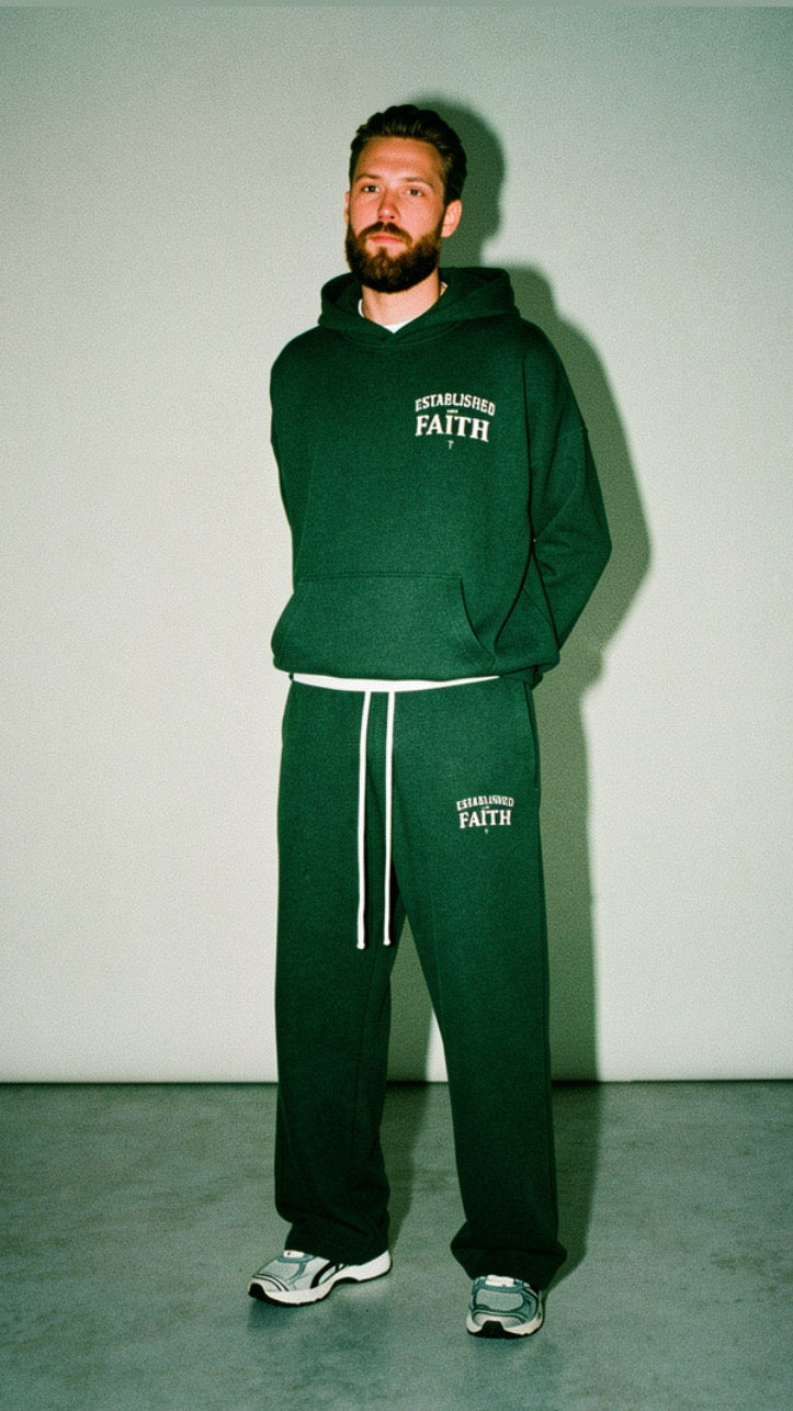 Young adult wearing oversized Christian hoodie outdoors